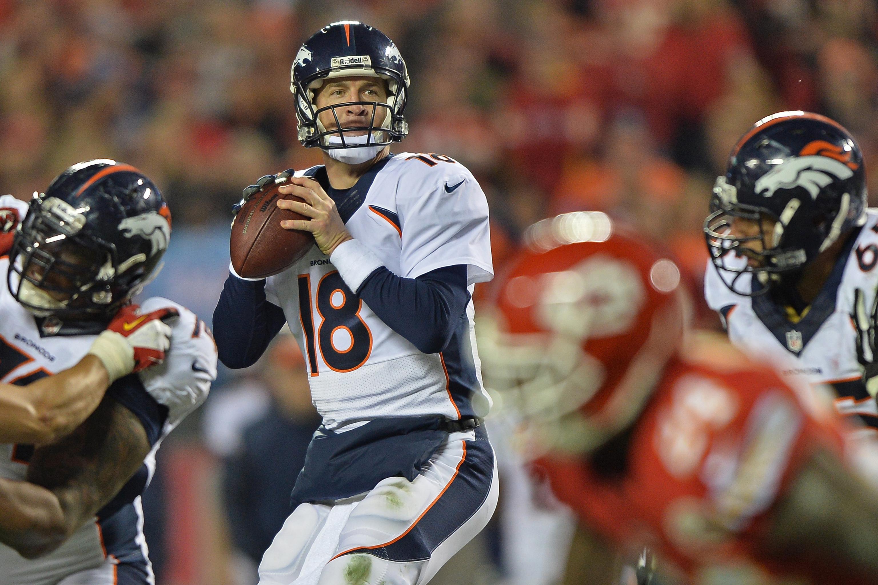 Denver Broncos quarterback Peyton Manning (18) unhappily leaves the field  after another Broncos drive ended in a punt during the first half of play  on Sunday afternoon. Manning and the Broncos lost