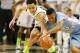 Nate Britt and Travis Trice battle for the loose ball.