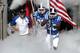 Sep 28, 2013; Durham, NC, USA; Duke Blue Devils head coach David Cutcliffe runs out onto the field with tight end Dan Beilinson (85) and wide receiver Brandon Watkins (30) before the start of their game against the Troy Trojans at Wallace Wade Stadium. Mandatory Credit: Mark Dolejs-USA TODAY Sports