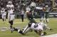 EAST RUTHERFORD, NJ - DECEMBER 8: Geno Smith #7 of the New York Jets tumbles over Brandian Ross #29 of the Oakland Raiders during their game at MetLife Stadium on December 8, 2013 in East Rutherford, New Jersey. (Photo by Jeff Zelevansky/Getty Images)
