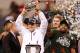 INDIANAPOLIS, IN - DECEMBER 07: Head coach Mark Dantonio of the Michigan State Spartans holds up the Big Ten championship trophy next to Denicos Allen #28 after defeating the Ohio State Buckeyes 34-24 at the Big 10 Conference Championship Game at Lucas Oil Stadium on December 7, 2013 in Indianapolis, Indiana. (Photo by Gregory Shamus/Getty Images)