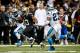Dec 8, 2013; New Orleans, LA, USA; New Orleans Saints running back Darren Sproles (43) runs as Carolina Panthers strong safety Quintin Mikell (27) and cornerback Drayton Florence (29) chase during the first half of a game at Mercedes-Benz Superdome. The Saints defeated the Panthers 31-13. Mandatory Credit: Derick E. Hingle-USA TODAY Sports