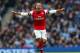 MANCHESTER, ENGLAND - DECEMBER 14: Theo Walcott of Arsenal celebrates scoring their first goal during the Barclays Premier League match between Manchester City and Arsenal at Etihad Stadium on December 14, 2013 in Manchester, England. (Photo by Clive Brunskill/Getty Images)