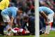 MANCHESTER, ENGLAND - DECEMBER 14: Samir Nasri of Manchester City speaks to Laurent Koscielny of Arsenal as he receives treatment during the Barclays Premier League match between Manchester City and Arsenal at Etihad Stadium on December 14, 2013 in Manchester, England. (Photo by Clive Brunskill/Getty Images)