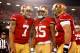 Jan 12, 2013; San Francisco, CA, USA; San Francisco 49ers wide receiver Michael Crabtree (15) celebrates with quarterback Colin Kaepernick (7) and center Jonathan Goodwin (59) after scoring a touchdown against the Green Bay Packers during the second quarter of the NFC divisional round playoff game at Candlestick Park. The 49ers defeated the Packers 45-31. Mandatory Credit: Cary Edmondson-USA TODAY Sports