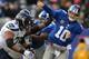EAST RUTHERFORD, NJ - DECEMBER 15: Quarterback Eli Manning #10 of the New York Giants is hit as he throws a pass in the 1st half against the Seattle Seahawks at MetLife Stadium on December 15, 2013 in East Rutherford, New Jersey. (Photo by Ron Antonelli/Getty Images)