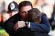 LIVERPOOL, ENGLAND - DECEMBER 21: Cardiff City manager Malky Mackay (L) is embraced by Liverpool manager Brendan Rogers (R) before the Barclays Premier League match between Liverpool and Cardiff City at Anfield on December 21, 2013 in Liverpool, England. (Photo by Clive Brunskill/Getty Images)