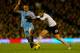 LONDON, ENGLAND - DECEMBER 21: Vincent Kompany of Manchester City tackles Adel Taarabt of Fulham during the Barclays Premier League match between Fulham and Manchester City at Craven Cottage on December 21, 2013 in London, England. (Photo by Clive Rose/Getty Images)