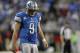 Dec 22, 2013; Detroit, MI, USA; Detroit Lions quarterback Matthew Stafford (9) looks down during overtime against the New York Giants at Ford Field. Giants beat the Lions 23-20. Mandatory Credit: Raj Mehta-USA TODAY Sports