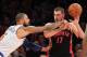 Dec 27, 2013; New York, NY, USA; New York Knicks center Tyson Chandler (6) swipes at a ball controlled by Toronto Raptors center Jonas Valanciunas (17) during the third quarter of a game at Madison Square Garden. Mandatory Credit: Brad Penner-USA TODAY Sports