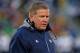 SOUTH BEND, IN - NOVEMBER 02: Head coach Brian Kelly of the Notre Dame Fighting Irish walks off of the field after checking on an injured player during a game against the Navy Midshipmen at Notre Dame Stadium on November 2, 2013 in South Bend, Indiana. Notre Dame defeated Navy 38-34. (Photo by Jonathan Daniel/Getty Images)