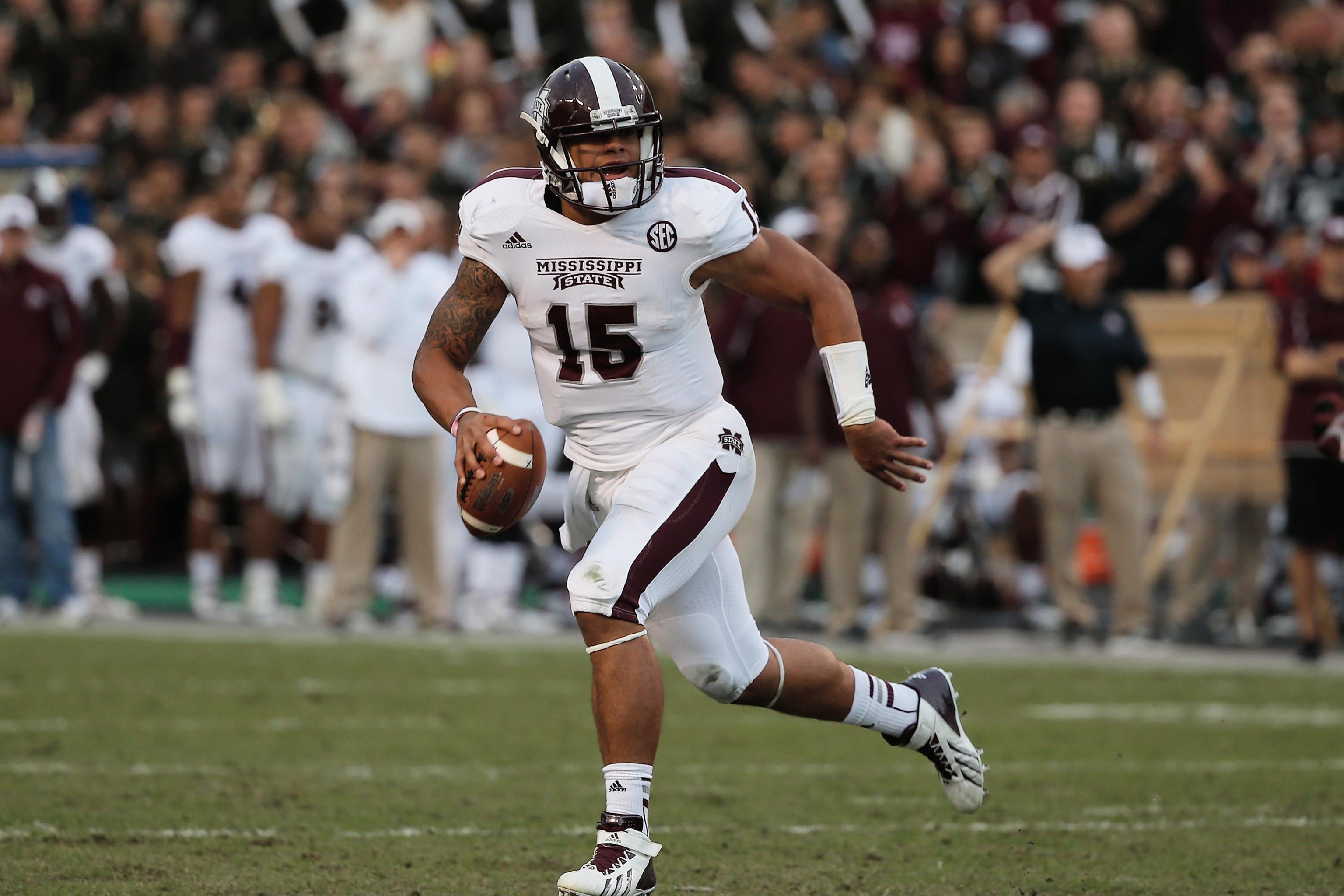 Dak Prescott Mississippi State Bulldogs Unsigned Maroon Jersey Touchdown Celebration During Liberty Bowl Photograph