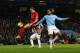 MANCHESTER, ENGLAND - DECEMBER 26: Jordan Henderson of Liverpool is challenged by Joleon Lescott of Manchester City as he shoots from close range during the Barclays Premier League match between Manchester City and Liverpool at Etihad Stadium on December 26, 2013 in Manchester, England. (Photo by Jan Kruger/Getty Images)