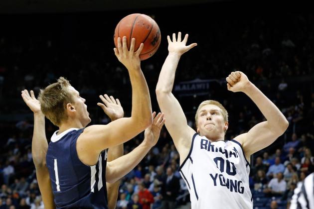 Jan 4, 2014; Provo, UT, USA; San Diego Toreros guard Johnny Dee (1) shoots the ball while Brigham Young Cougars forward Eric Mika (00) tries to block the shot during the first half at Marriott Center. Mandatory Credit: Chris Nicoll-USA TODAY Sports