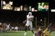 PASADENA, CA - JANUARY 04: Vince Young #10 of the Texas Longhorns runs past Frostee Rucker #90 of the USC Trojans to score a touchdown and put the Longhorns up by one in the final moments of the BCS National Championship Rose Bowl Game at the Rose Bowl on January 4, 2006 in Pasadena, California. Texas defeated USC 41-38. (Photo by Harry How/Getty Images)