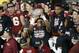 Jan 6, 2014; Pasadena, CA, USA; Florida State Seminoles quarterback Jameis Winston (5) holds the Coaches Trophy after defeating the Auburn Tigers 34-31 in the 2014 BCS National Championship game at the Rose Bowl. Mandatory Credit: Kelvin Kuo-USA TODAY Sports