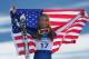 WHISTLER, BC - FEBRUARY 20: Bronze medalist Lindsey Vonn of the United States celebrates with the American flag after the women's alpine skiing Super-G on day nine of the Vancouver 2010 Winter Olympics at Whistler Creekside on February 20, 2010 in Whistler, Canada. (Photo by Shaun Botterill/Getty Images)