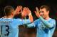 MANCHESTER, ENGLAND - JANUARY 08: Edin Dzeko of Manchester City celebrates scoring their sixth goal with Aleksandar Kolarov of Manchester City during the Capital One Cup Semi-Final first leg match between Manchester City and West Ham United at Etihad Stadium on January 8, 2014 in Manchester, England. (Photo by Shaun Botterill/Getty Images)