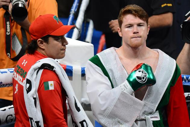 LAS VEGAS, NV - SEPTEMBER 14:  Canelo Alvarez (R) and his co-trainer Eddy Reynoso enter the ring to take on Floyd Mayweather Jr. in their WBC/WBA 154-pound title fight at the MGM Grand Garden Arena on September 14, 2013 in Las Vegas, Nevada.  (Photo by Ethan Miller/Getty Images)