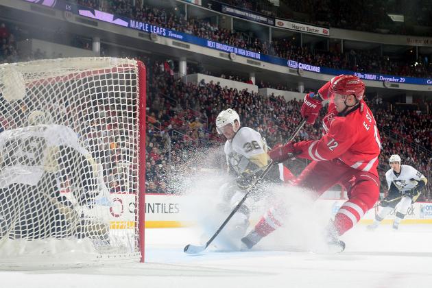 RALEIGH, NC - DECEMBER 27:  Eric Staal #12 of the Carolina Hurricanes looks for a crossing pass as he slides to the top of the crease defended by Marc-Andre Fleury #29 of the Pittsburgh Penguins during an NHL game on December 27, 2013 at PNC Arena in Raleigh, North Carolina.  (Photo by Phil Ellsworth/NHLI via Getty Images)