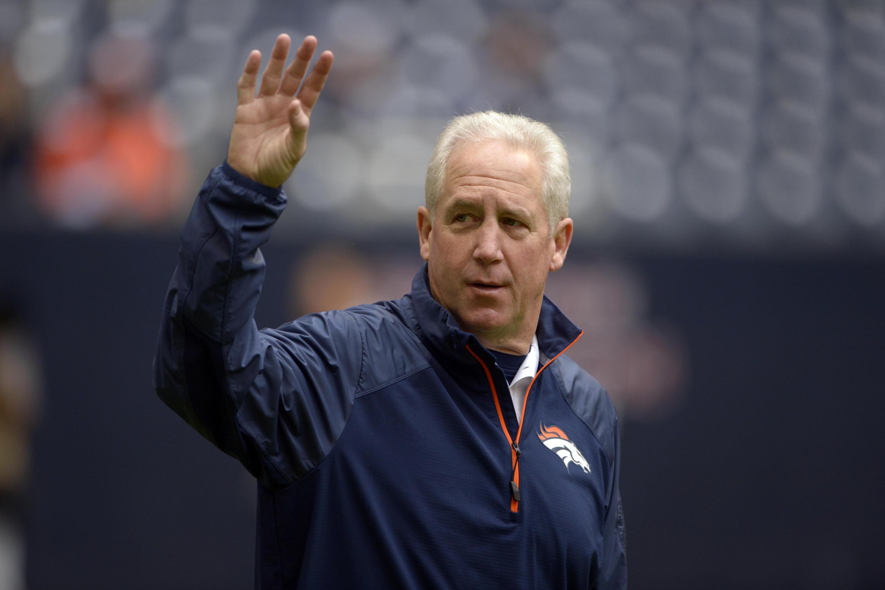 Head coach John Fox talks to Tim Tebow during the second half of