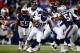 FOXBORO, MA - NOVEMBER 24: Running back Knowshon Moreno #27 of the Denver Broncos carries the ball against the New England Patriots during a game at Gillette Stadium on November 24, 2013 in Foxboro, Massachusetts. (Photo by Jared Wickerham/Getty Images)
