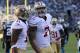 Jan 12, 2014; Charlotte, NC, USA; San Francisco 49ers quarterback Colin Kaepernick (7) celebrates a touchdown with wide receiver Quinton Patton (11) against the Carolina Panthers during the third quarter of the 2013 NFC divisional playoff football game at Bank of America Stadium. Mandatory Credit: Sam Sharpe-USA TODAY Sports