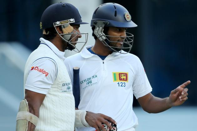 DUBAI, UNITED ARAB EMIRATES - JANUARY 08:  Dimuth Karunaratne (R) of Sri Lanka talks to team mate Kumar Sangakkara (L) during the first day of the second Test match between Pakistan and Sri Lanka at the Dubai Sports City Cricket Stadium on January 8, 2014 in Dubai, United Arab Emirates.  (Photo by Francois Nel/Getty Images)