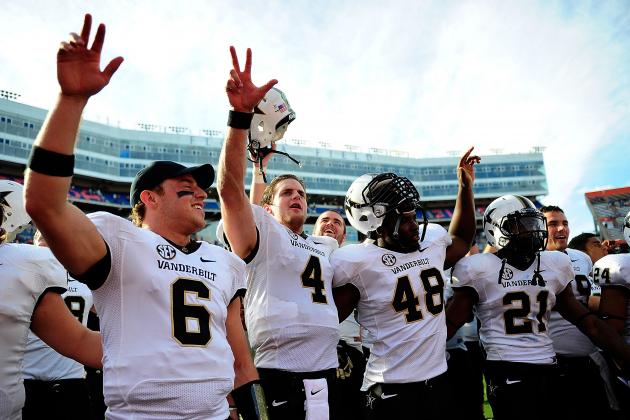 GAINESVILLE, FL - NOVEMBER 09: Austin Carta-Samuels #6, Patton Robinette #4, Nigel Bowden #48 and Paris Head #21 of the Vanderbilt Commodores celebrate a victory over the Florida Gators following a game at Ben Hill Griffin Stadium on November 9, 2013 in Gainesville, Florida. Vanderbilt won the game 34-17. (Photo by Stacy Revere/Getty Images)