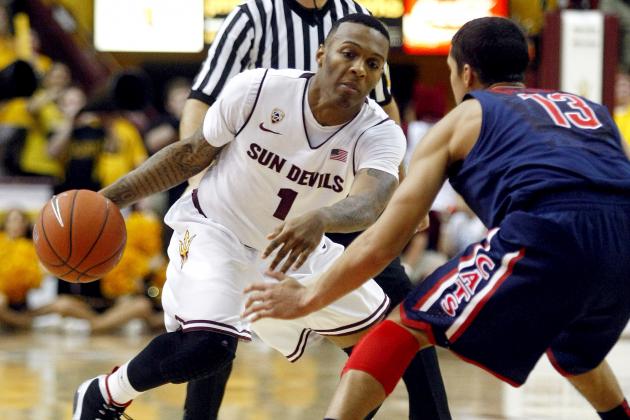 January 19, 2013; Tempe, AZ, USA; Arizona State Sun Devils guard Jahii Carson (1) drives on Arizona Wildcats guard Nick Johnson (13) during the second half at Wells Fargo Arena. Mandatory Credit: Rick Scuteri-USA TODAY Sports