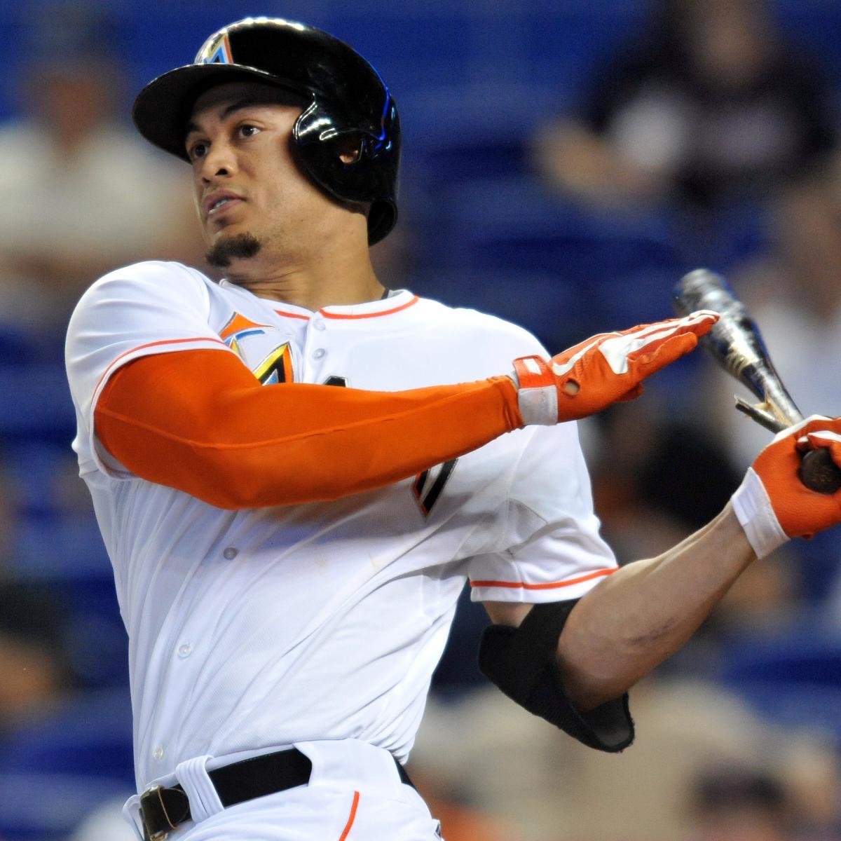 FILE - Clockwise from top left are 2017 file photos showing: Miami Marlins' Giancarlo  Stanton hitting a two-run home run during the third inning against the  Washington Nationals in Washington; Giancarlo Stanton