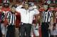 Ohio State coach Urban Meyer stands with officials as they wait for a ruling on the field during the first half of the Orange Bowl NCAA college football game against Clemson, Friday, Jan. 3, 2014, in Miami Gardens, Fla. (AP Photo/Lynne Sladky)