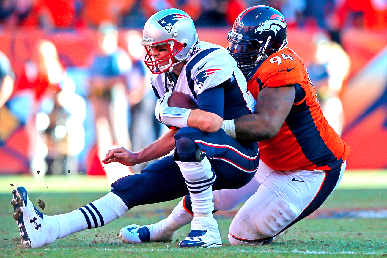 Tom Brady (12) of the New England Patriots throws a pass during the AFC  Championship game at Sports Authority Field at Mile High in Denver on  January 19, 2014. The New England-Denver