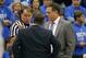 Referee John Higgins, middle, explains a call to Oklahoma State head coach Travis Ford, left, and Kansas head coach Bill Self, right, during the first half of an NCAA college basketball game at Allen Fieldhouse in Lawrence, Kan., Saturday, Jan. 18, 2014. (AP Photo/Orlin Wagner)