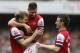 Arsenal's Per Mertesacker, left, celebrates with teammates Oliver Giroudafter, centre, and Laurent Koscielny after scoring the second goal against Stoke during the English Premier League soccer match between Arsenal and Stoke City at Emirates Stadium in London, Sunday, Sept. 22, 2013. (AP Photo/Sang Tan)
