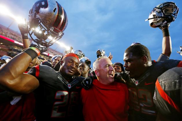 PISCATAWAY, NJ - SEPTEMBER 21: Savon Huggins #28, head coach Kyle Flood and Jamil Merrell #92 of the Rutgers Scarlet Knights celebrate their 28-24 victory over the Arkansas Razorbacks in a game at High Point Solutions Stadium on September 21, 2013 in Piscataway, New Jersey. (Photo by Rich Schultz /Getty Images)