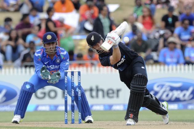 New Zealand's Kane Williamson, right, hits a boundary in front of India’s wicketkeeper MS Dhoni in the second one-day International cricket match at Seddon Park in Hamilton, New Zealand, Wednesday, Jan. 22, 2014. (AP Photo/SNPA, Ross Setford) NEW ZEALAND OUT