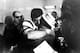 American Football League New York Jets quarterback Joe Namath gives his father, who is wearing an Orange Bowl hat, a big hug in the Jets' crowded dressing room on Jan. 12, 1969. Namath led his underdog team to a 16 to 7 win over the National Football League champion Baltimore Colts in the Super Bowl III game in Miami, Fla. (AP Photo)
