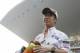 Sauber driver Kamui Kobayashi of Japan holds a scarf during the drivers parade before the Indian Formula One Grand Prix, at the Buddh International Circuit in Noida, on the outskirts of New Delhi, India, Sunday, Oct. 28, 2012. (AP Photo/Greg Baker)