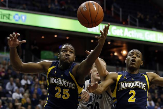 Marquette forward Steve Taylor, Jr. (25) grabs a rebound in front of Georgetown forward Nate Lubick (34) and guard John Dawson (2) during the second half of an NCAA college basketball game, Monday, Jan. 20, 2014, in Washington. Marquette won 80-72 in overtime. (AP Photo/Alex Brandon)