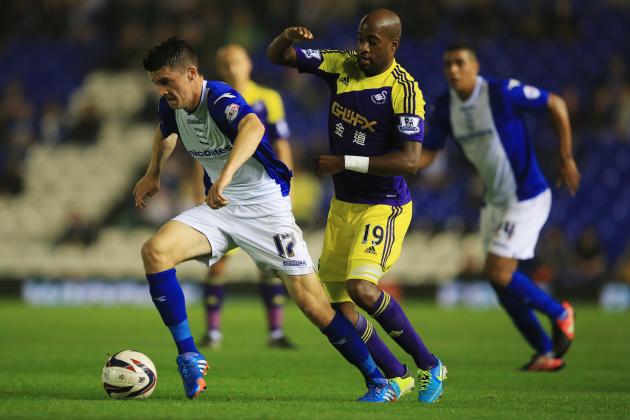 BIRMINGHAM, ENGLAND - SEPTEMBER 25: Callum Reilly of Birmingham City evades Dwight Tiendalli of Swansea City during the Capital One Cup Third Round match between Birmingham City and Swansea City at St Andrews on September 25, 2013 in Birmingham, England. (Photo by Richard Heathcote/Getty Images)