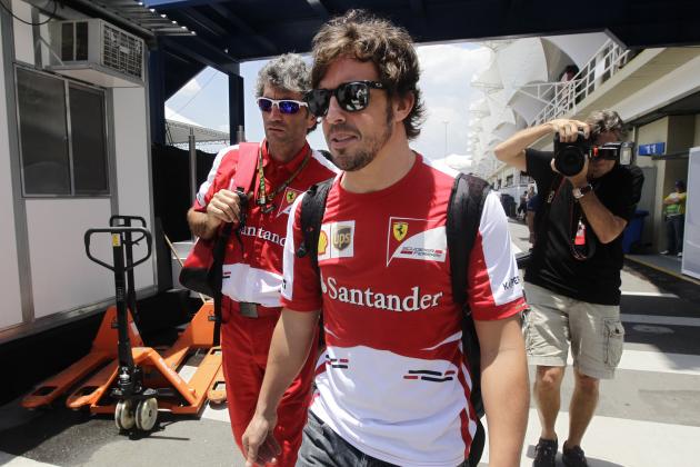Ferrari driver Fernando Alonso of Spain, center front, arrives to the Interlagos race track in Sao Paulo, Brazil, Thursday, Nov. 21, 2013. Alonso will compete Sunday in the season-ending Brazilian Formula One Grand Prix at Sao Paulo's Interlagos circuit. (AP Photo/Silvia Izquierdo)