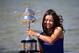 China's Li Na poses for photos at Brighton Beach with her Australian Open trophy following her win over Slovakia's Dominika Cibulkova in Melbourne, Australia, Sunday, Jan. 26, 2014. (AP Photo/Aaron Favila)