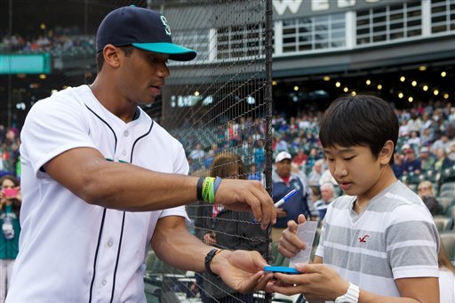 Russell Wilson will be featured on a Topps baseball card as a Texas Ranger