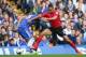 Chelsea's John Terry, left, is tackled by Cardiff's Peter Odemwingie during their English Premier League soccer match at Chelsea's Stamford Bridge stadium in London, Saturday Oct. 19, 2013. (AP Photo/Alastair Grant)