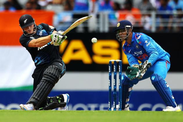 AUCKLAND, NEW ZEALAND - JANUARY 25: Martin Guptill of New Zealand bats as MS Dhoni of India looks on during the One Day International match between New Zealand and India at Eden Park on January 25, 2014 in Auckland, New Zealand.  (Photo by Anthony Au-Yeung/Getty Images)