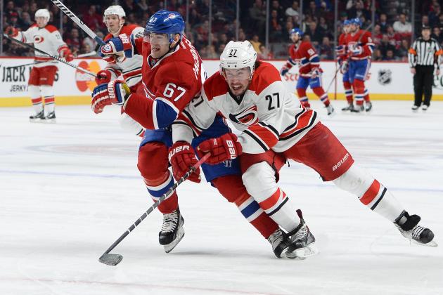 MONTREAL, QC - JANUARY 28: Max Pacioretty #67 of the Montreal Canadiens, fights for the puck against Justin Faulk #27 of the Carolina Hurricanes during the NHL game on January 28, 2014 at the Bell Centre in Montreal, Quebec, Canada. (Photo by Francois Lacasse/NHLI via Getty Images)