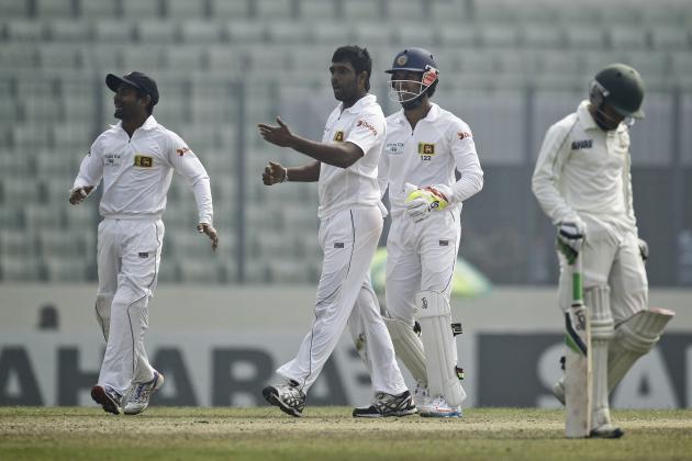 Sri Lanka’s Dilruwan Perera, second left, celebrates the wicket of Bangladesh's Mominul Haque, right, on the fourth day of their first test cricket match in Dhaka, Bangladesh, Thursday, Jan. 30, 2014. (AP Photo/A.M. Ahad)
