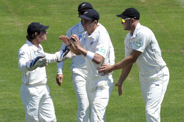 New Zealand's Tim Southee, center, celebrates with B J Watling, left, and Peter Fulton after taking a slip catch to dismiss West Indies Kieron Powell on the third day of their international cricket match in Dunedin, New Zealand, Thursday, Dec. 5, 2013. (AP Photo/SNPA, Ross Setford) NEW ZEALAND OUT