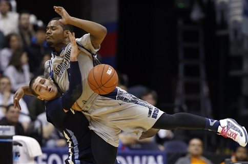Georgetown guard D'Vauntes Smith-Rivera, right collides with Villanova guard Ryan Arcidiacono (15) after he attempted to shoot, during the second half of an NCAA college basketball game, Monday, Jan. 27, 2014, in Washington. Villanova won 65-60. (AP Photo/Alex Brandon)